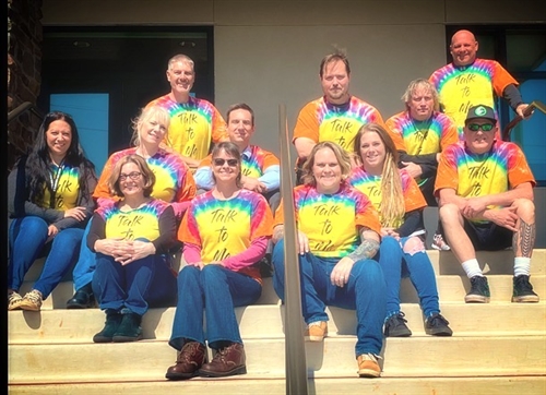 Group of Ridgeview High staff wearing tie dye shirts that say 